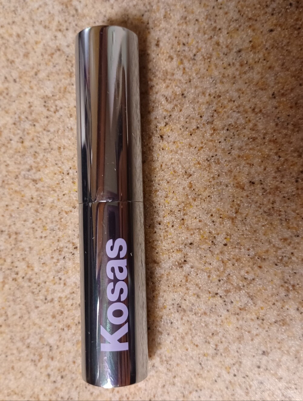 × Kosas Metallic Silver Lipstick Tube with Lilac Logo